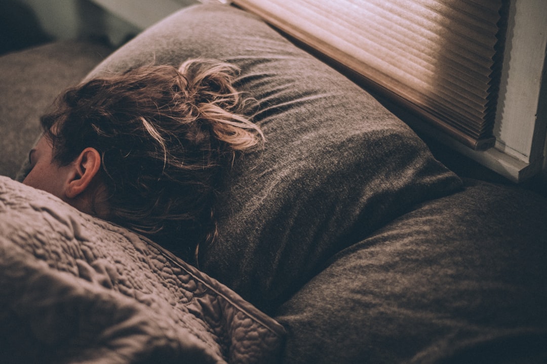 Woman sleeping on gray bedding