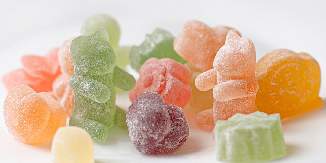 Assorted colorful gummy candies on white background