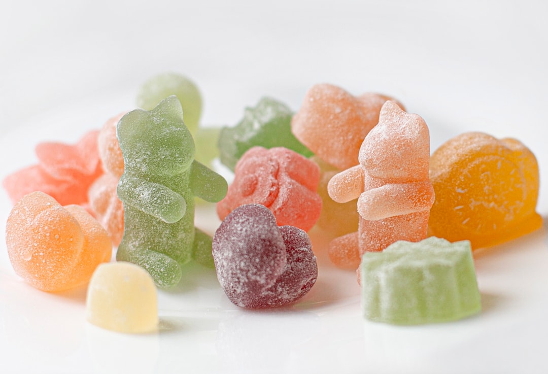 Assorted colorful gummy candies on white background