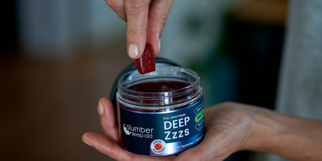 Person picks gummy from Deep Zzzs jar