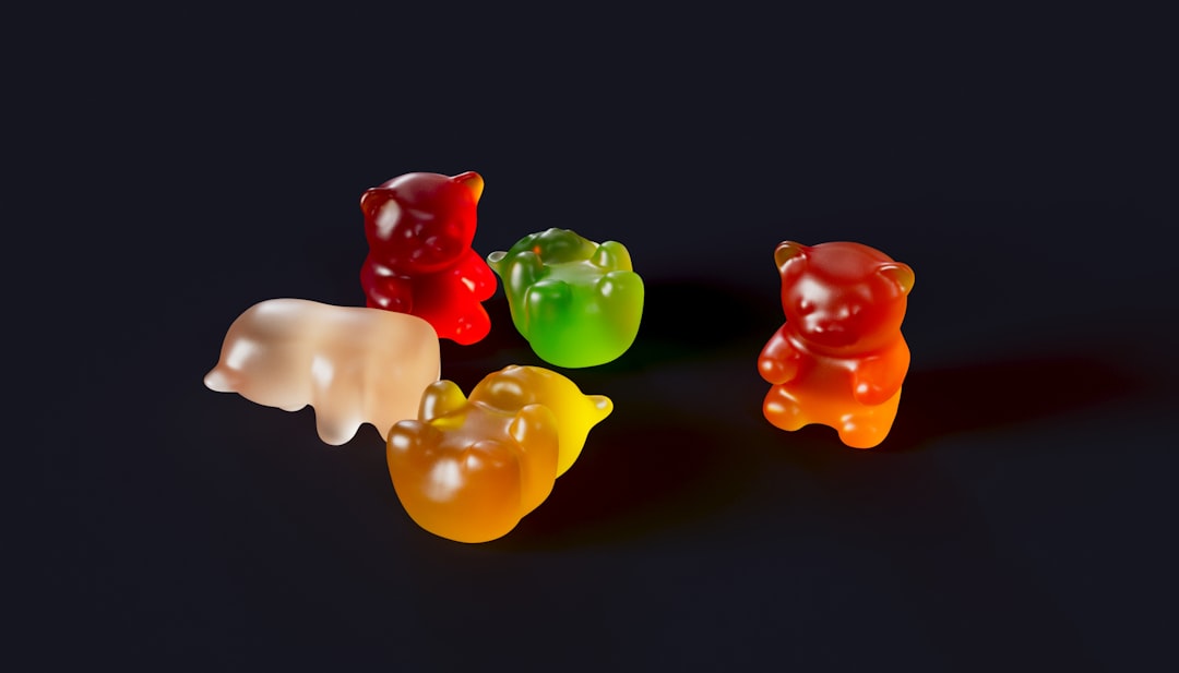 Five assorted gummy bears on a black background