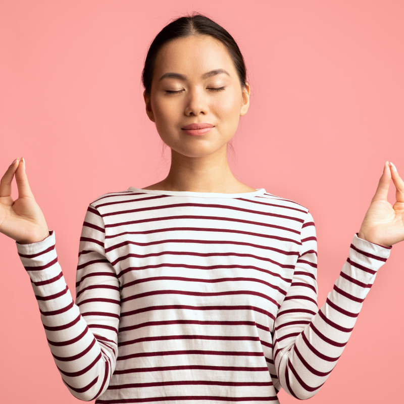 Person wearing a striped shirt against a pink background