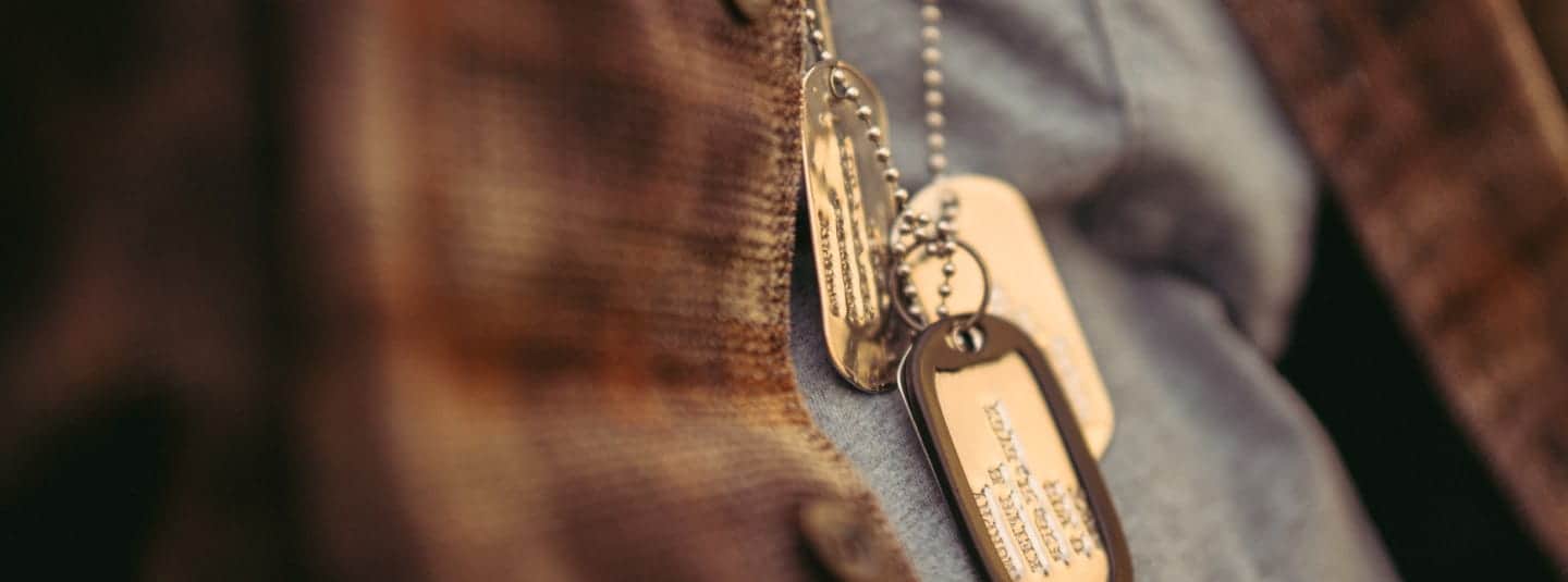 Closeup of a military person's dog tag necklaces