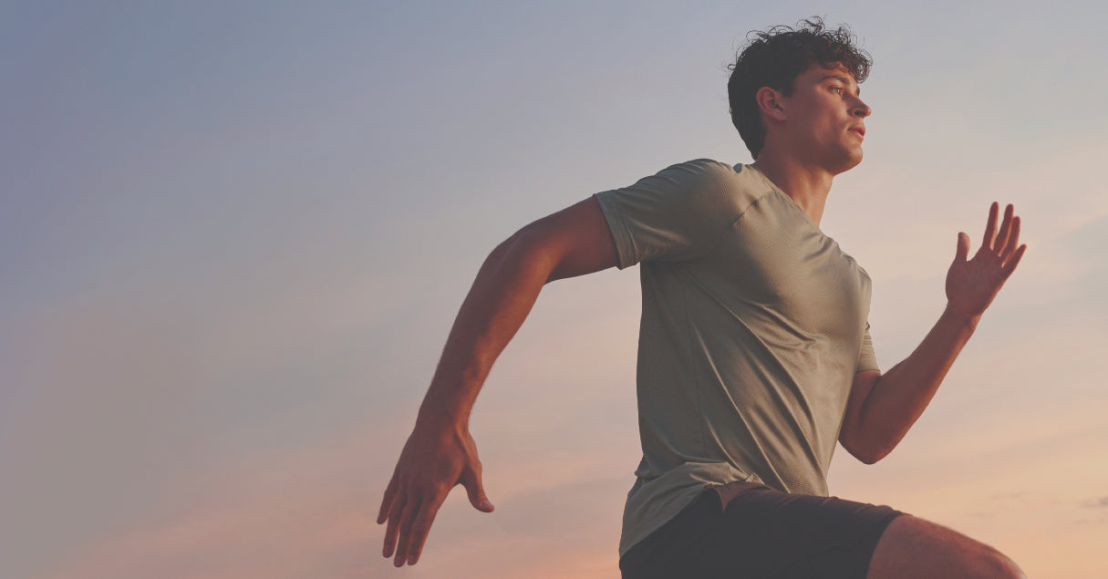 Person running outdoors with a gradient sky background