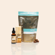 Product Image for CBD Calm gummies pouch, oil dropper bottle, and branded box arranged on a neutral surface with brown gummies in front.