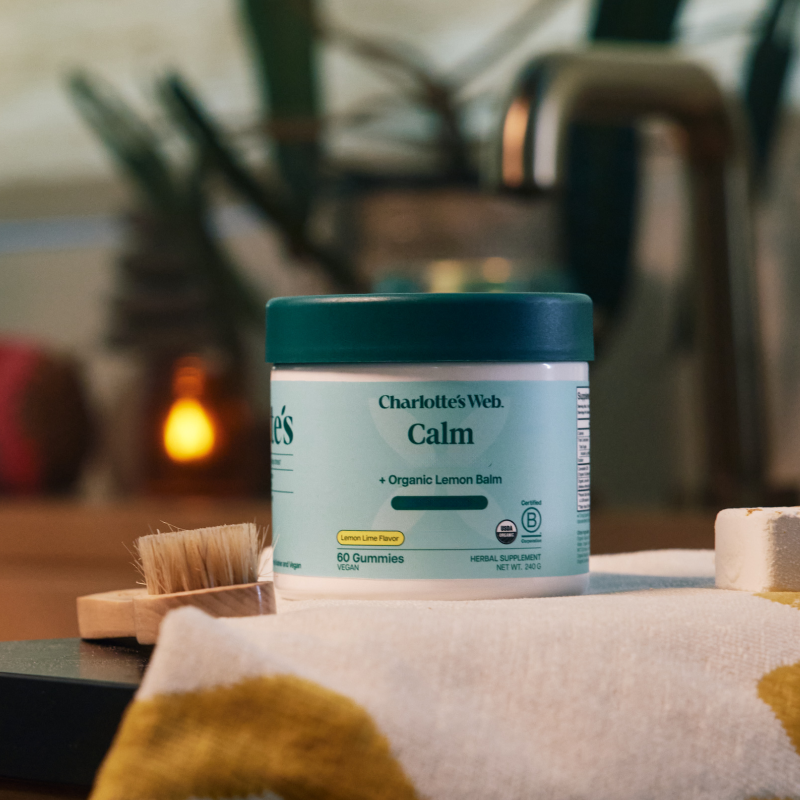 Jar of Charlotte's Web Calm gummies on a surface with a blurred background