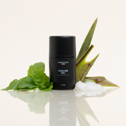 Product Image for Black bottle of Charlotte&#39;s Web Cooling Gel with aloe vera leaves on a reflective surface