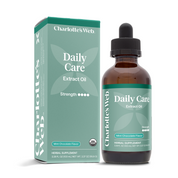 Product Image for Charlotte's Web Daily Care Extract Oil herbal supplement, shown in an amber glass dropper bottle next to its mint green packaging box on a white background.