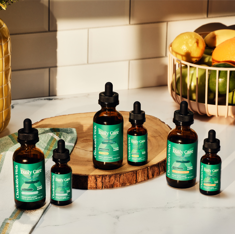 Bottle of Daily Care on a wooden board with a kitchen background