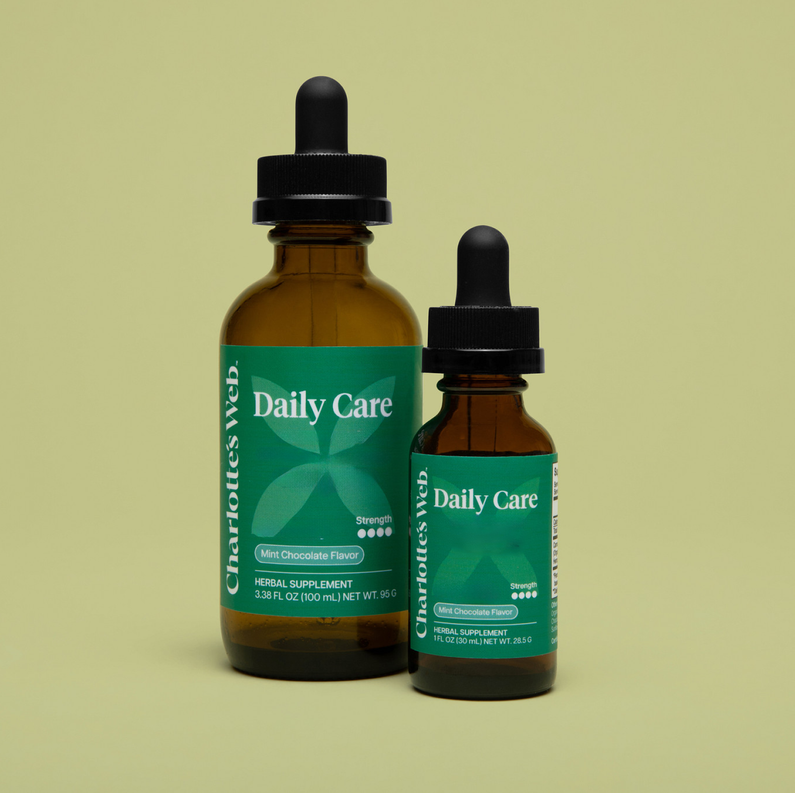 Product Image for Two bottles of Charlotte&#39;s Web Daily Care herbal supplement on a beige background