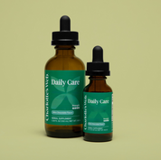 Product Image for Two bottles of Charlotte&#39;s Web Daily Care herbal supplement on a beige background