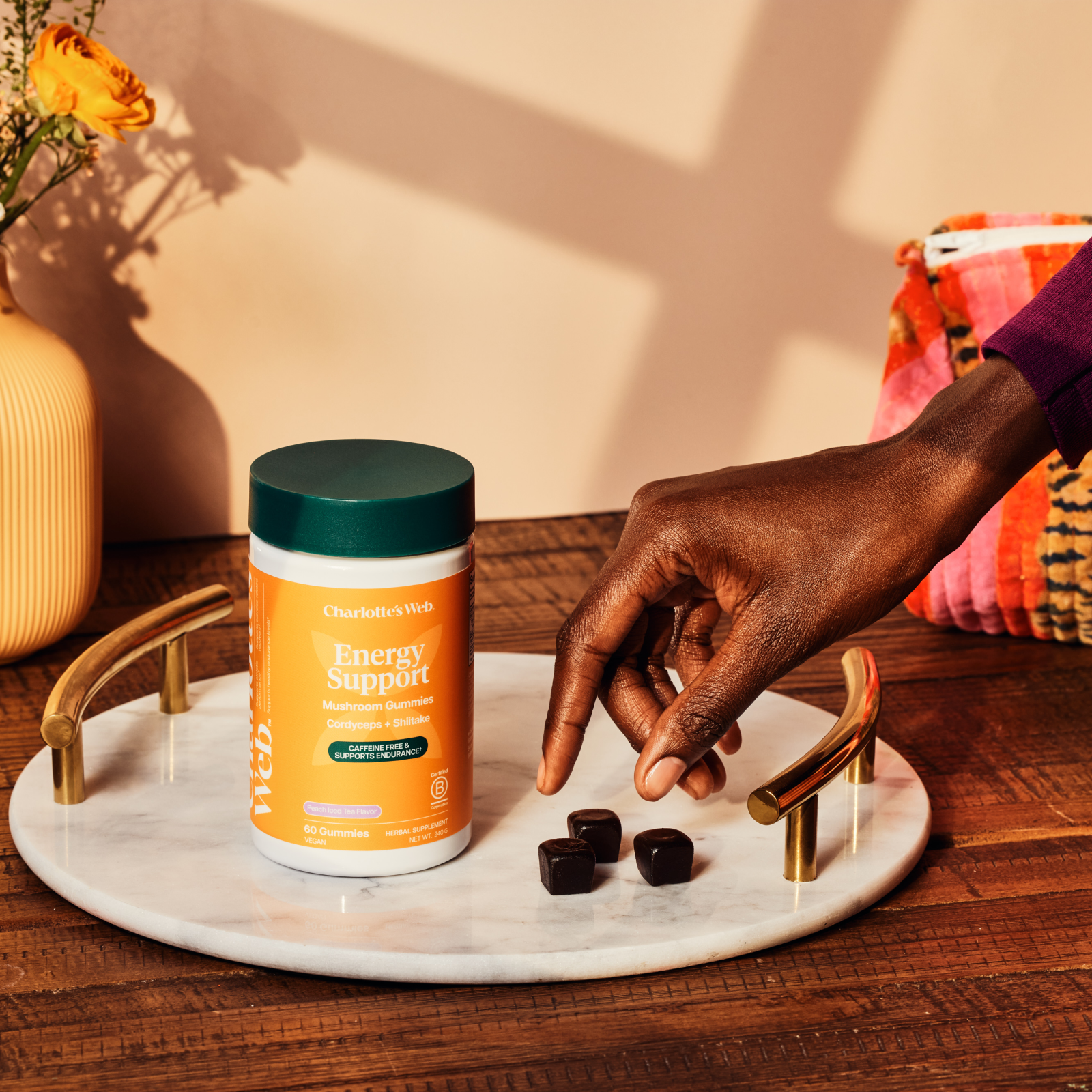 Product Image for Hand reaching for supplements on a marble tray with a supplement bottle labeled &#39;Energy Support&#39; in the background.