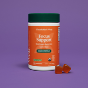 Product Image for Charlotte&#39;s Web Focus Support mushroom gummies container with two gummies on a purple background