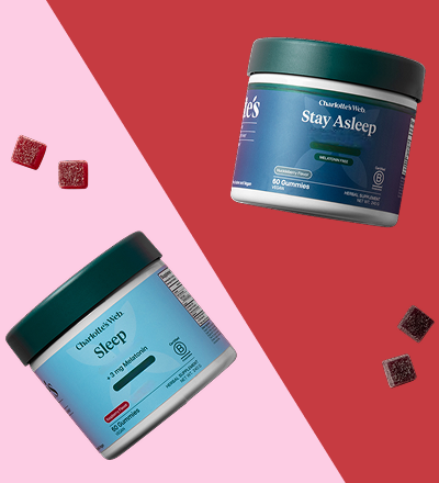 Two jars of Charlotte's Web 'Sleep' and 'Stay Asleep' gummies on a pink and red background