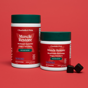 Product Image for Two containers of Charlotte&#39;s Web Muscle Restore Mushroom Gummies on a red background