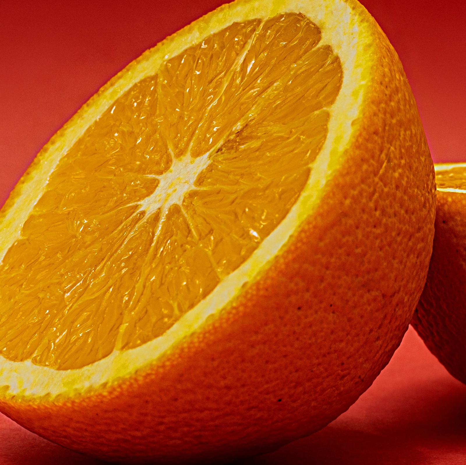 Product Image for Close-up of a sliced orange on a red background