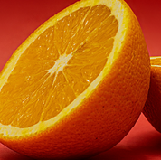 Product Image for Close-up of a sliced orange on a red background
