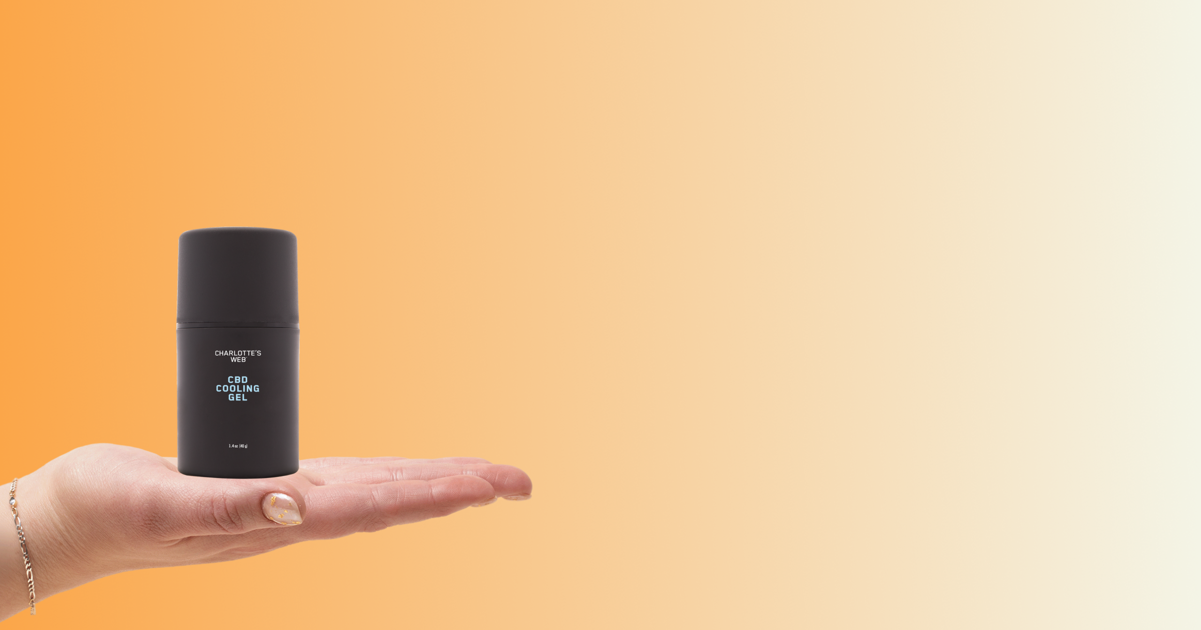 Hand holding a black cylindrical container against an orange gradient background