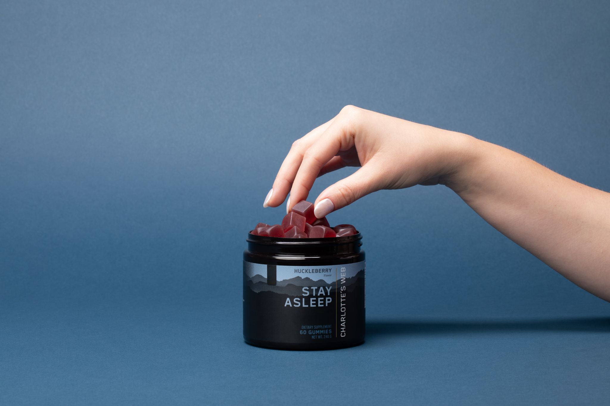 Hemp Isolate stay asleep gummy with a hand grabbing it